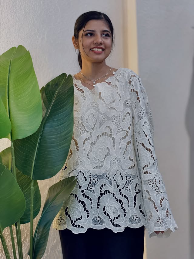 Model wearing a white lace top at Rozzo