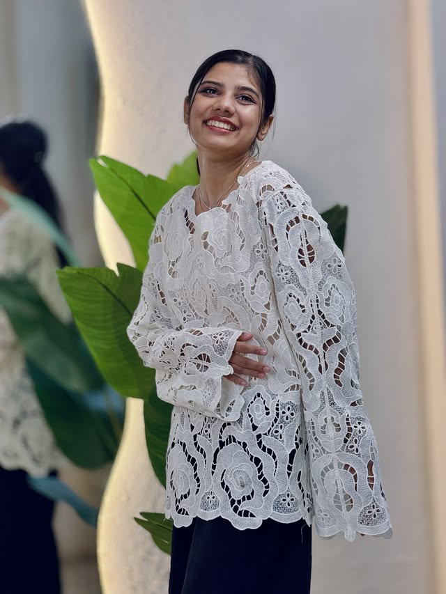 Rozzo model wearing a white floral lace top